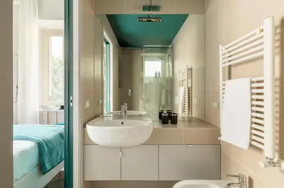 a bathroom with a sink and a mirror at YCH-Colosseo book house in Rome