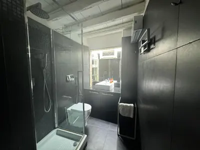 a bathroom with a shower and a toilet and a sink at In Ancient Rome Apartment in Rome