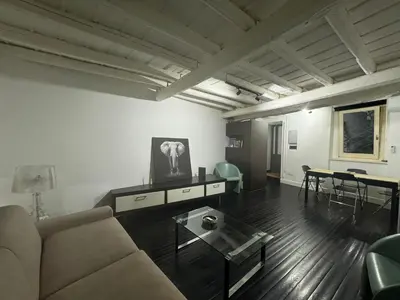 a living room with a couch and a table at In Ancient Rome Apartment in Rome