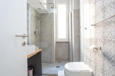 a bathroom with a toilet and a sink and a shower at Elegantis Des Artistes Apartment in Rome