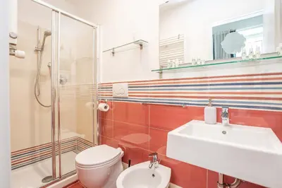 a bathroom with a toilet and a sink and a shower at Elegantis Des Artistes Apartment in Rome
