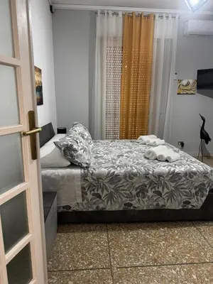 a bedroom with two beds and a window at Giosephine House in Rome
