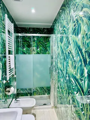 a bathroom with a green mural of plants on the wall at Milazzo Suites in Rome