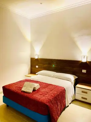 a bedroom with a bed with a red blanket at Milazzo Suites in Rome