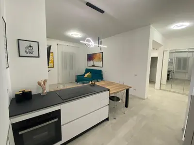 a kitchen with a counter top and a table at Casa vacanze Belsito in Rome
