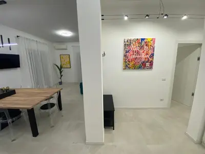 a dining room with a table and a painting on the wall at Casa vacanze Belsito in Rome