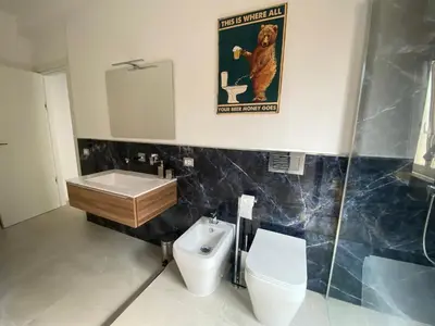 a bathroom with a monkey poster and a toilet at Casa vacanze Belsito in Rome