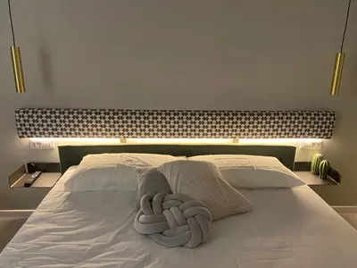 a white bed with two towels on top of it at Casa vacanze Belsito in Rome