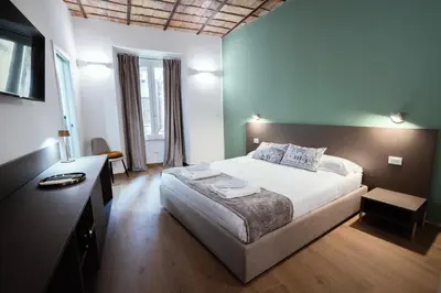 a bedroom with a bed and a desk with a television at Casa Fortuna 278 in Rome