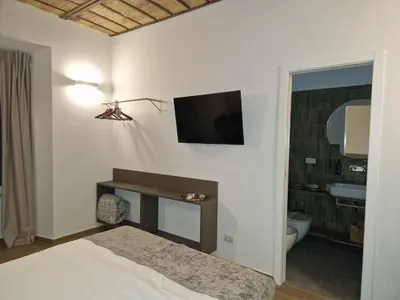 a bedroom with a bed and a television on the wall at Casa Fortuna 278 in Rome
