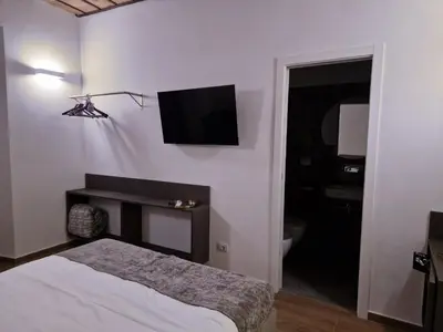 a bedroom with a bed and a television on the wall at Casa Fortuna 278 in Rome