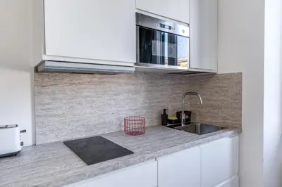 a kitchen with a sink and a microwave at St Peter Miracle Suite in Rome