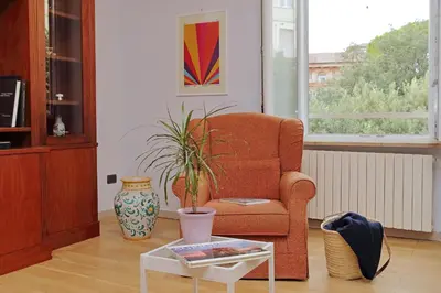a living room with a chair and a table at YCH-Luminoso appartamento nel cuore di Testaccio in Rome