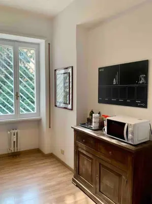 a living room with a microwave on a wooden table at Lovely apartment near Rome Vatican in Rome