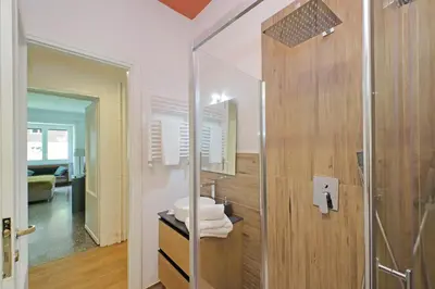 a bathroom with a glass shower with a sink at YCH-Riboty House al Vaticano in Rome