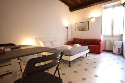 a room with a bed and a table and a couch at Lovely studio in Campo de Fiori in Rome