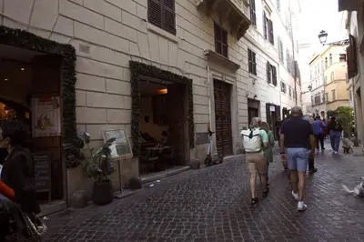 a group of people walking down a street at Top floor studio in Campo de Fiori in Rome