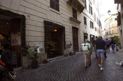 a group of people walking down a street at Top floor studio in Campo de Fiori in Rome