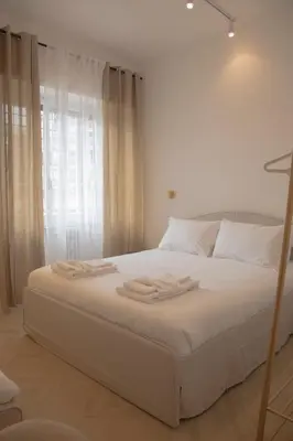 a white bed with two towels on top of it at San Pietro Luxury Relais in Rome