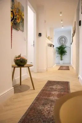 a hallway with a table and a vase on a table at San Pietro Luxury Relais in Rome