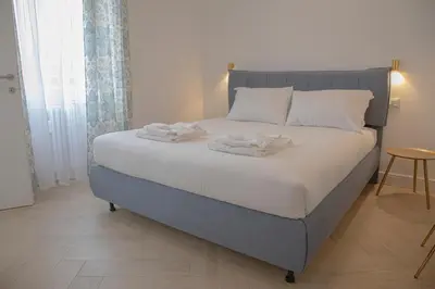 a bedroom with a bed with two towels on it at San Pietro Luxury Relais in Rome