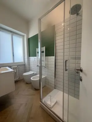 a bathroom with a shower and a toilet and a sink at San Pietro Luxury Relais in Rome
