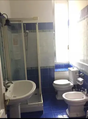 a bathroom with a toilet and a shower and a sink at Martino rooms Termini in Rome