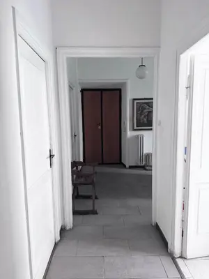 an empty hallway with a chair and two doors at Martino rooms Termini in Rome