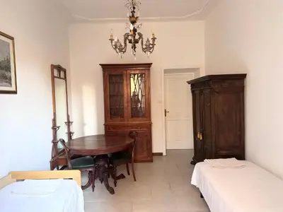 a room with a desk and a table in a room at Martino rooms Termini in Rome