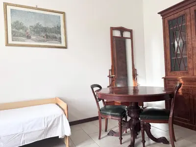 a bedroom with a table and chairs and a bed at Martino rooms Termini in Rome