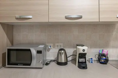a kitchen counter with a microwave and a coffee maker at Inside Rome in Rome