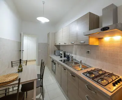 a kitchen with a sink and a stove top oven at Inside Rome in Rome