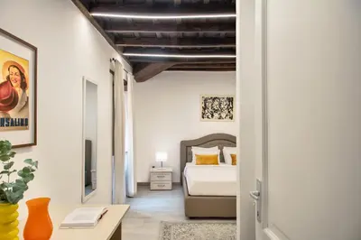 a bedroom with a bed and a desk in a room at Appartamento Roma Prefetti Suite in Rome