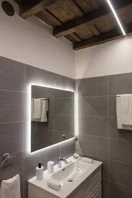 a bathroom with a sink and a mirror at Appartamento Roma Prefetti Suite in Rome