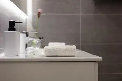 a bathroom counter with two towels and a sink at Appartamento Roma Prefetti Suite in Rome