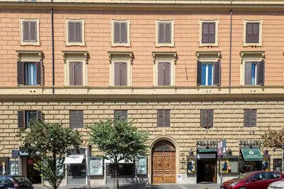 a large brick building with a brown door and windows at Charme e Lusso a San Pietro in Rome