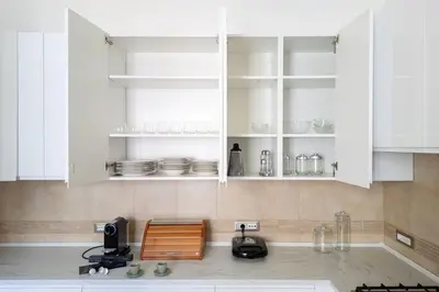 a kitchen with white cabinets and a counter top at Charme e Lusso a San Pietro in Rome