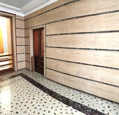 a room with a wall with stripes on it at san giovanni - re di roma apartment in Rome