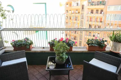 a balcony with chairs and potted plants on a balcony at Flaminio center house in Rome