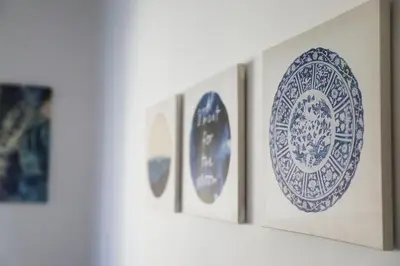 a row of blue and white plates on a wall at Flaminio center house in Rome