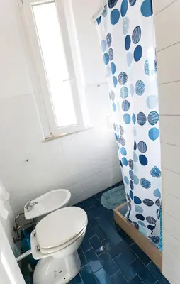 a bathroom with a toilet and a shower curtain at Flaminio center house in Rome