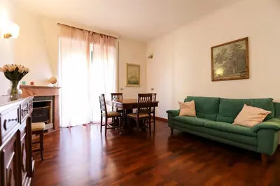 a living room with a green couch and a table at Flaminio center house in Rome