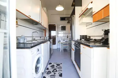 a kitchen with a washer and a sink and a dishwasher at Flaminio center house in Rome