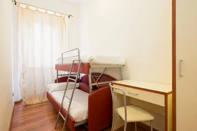 a room with two bunk beds and a desk at Navona Tower Apartments in Rome