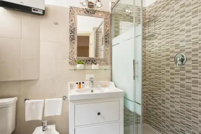 a bathroom with a sink and a shower with a mirror at Navona Tower Apartments in Rome