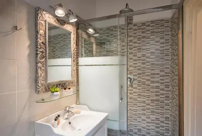 a bathroom with a sink and a shower with a mirror at Navona Tower Apartments in Rome