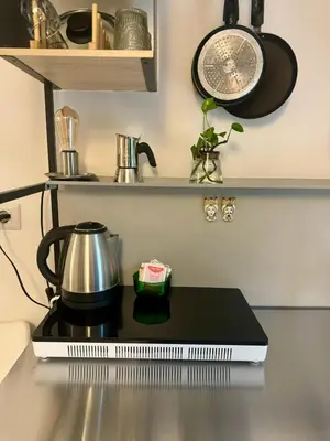 a kitchen counter with a tea kettle on a stove at Urban Oasis in Rome