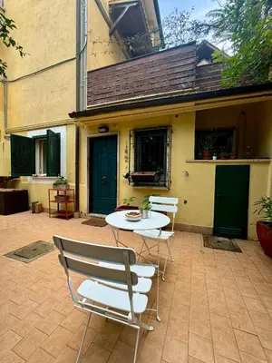 a patio with a table and chairs in front of a building at Urban Oasis in Rome