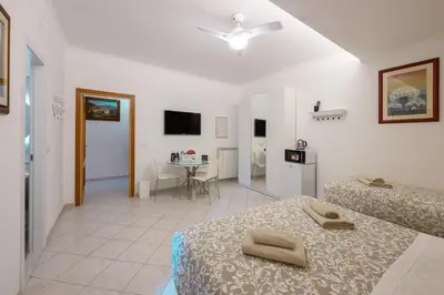 a bedroom with two beds and a room with a table at Triple room a few steps from Tiber in Rome