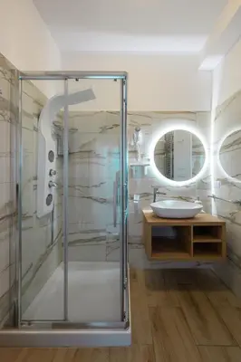 a bathroom with a glass shower and a sink at Triple room a few steps from Tiber in Rome